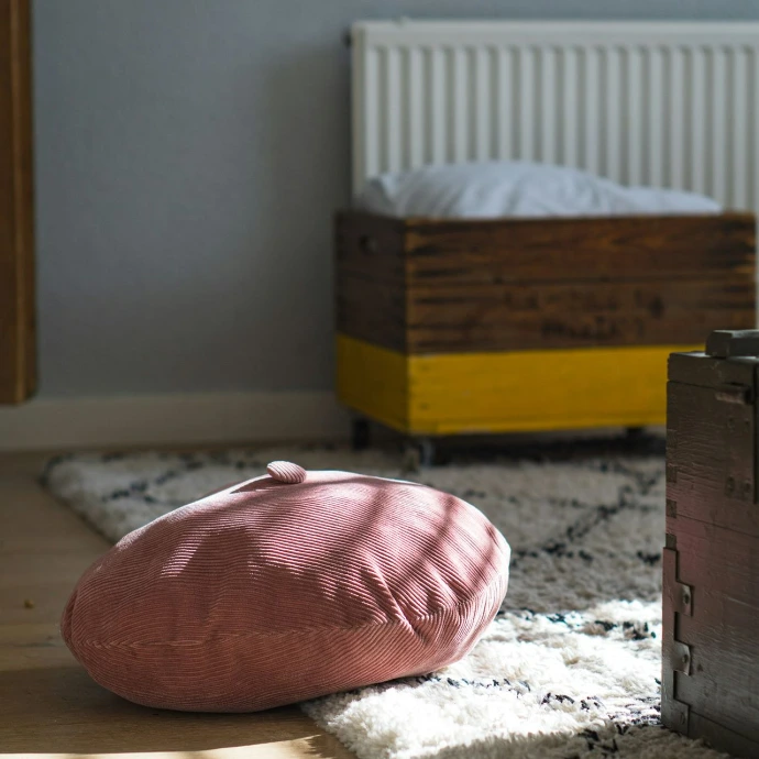 pink and white pillow on white and red floral bed linen